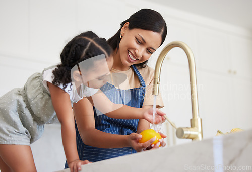 Image of Cleaning, mother and child washing vegetables with water for lunch, nutrition or breakfast in the kitchen of their house. Child learning to clean food while cooking with her mom before dinner