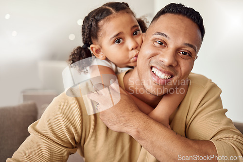 Image of Love, family and girl and father kiss on a sofa while bonding, relax and hug in a living room in their home together. Happy family, smile and portrait of loving child embrace parent on couch indoors