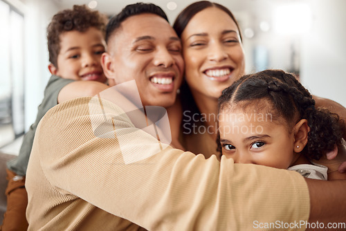 Image of Love, family and hug portrait in living room with Mexican parents and young kids in house. Care and happy latino man, woman and children enjoy cuddle together for care and affection in home