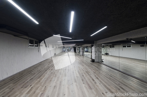 Image of An empty dance hall with a glass wall adorned with decorative graffiti, offering a fusion of contemporary, urban artistic ambiance and impressive aesthetics.