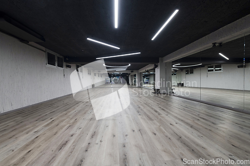 Image of An empty dance hall with a glass wall adorned with decorative graffiti, offering a fusion of contemporary, urban artistic ambiance and impressive aesthetics.