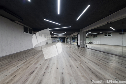 Image of An empty dance hall with a glass wall adorned with decorative graffiti, offering a fusion of contemporary, urban artistic ambiance and impressive aesthetics.