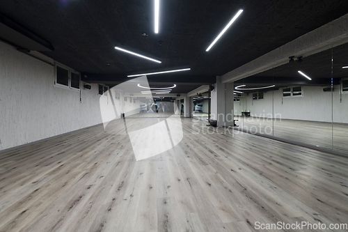 Image of An empty dance hall with a glass wall adorned with decorative graffiti, offering a fusion of contemporary, urban artistic ambiance and impressive aesthetics.