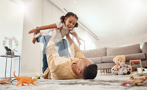 Image of Happy family, father and girl playing in a house with freedom, bonding and enjoying quality time together. Happiness, smile and child flying in dads arms on the floor on a weekend at home in Portugal