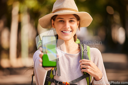 Image of Hiking, phone and woman with gps, map and navigation app on screen while hiking in forest, happy and relax. Portrait, girl and internet location for hiker on adventure in nature, excited and smiling