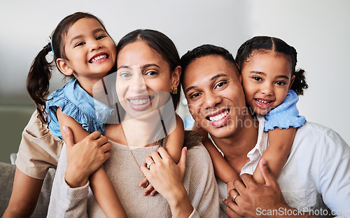 Image of Hug, children and parents on the sofa in the living room of their house for love, care and smile together. Face portrait of young, happy and hugging kids with affection for mother and father