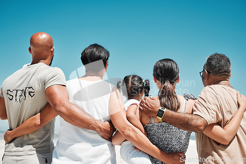 Image of Hug, support and big family at the beach for holiday, travel and relax by the sea in Bali with blue sky together in summer. Back of parents, girl and grandparents on vacation for peace and calm