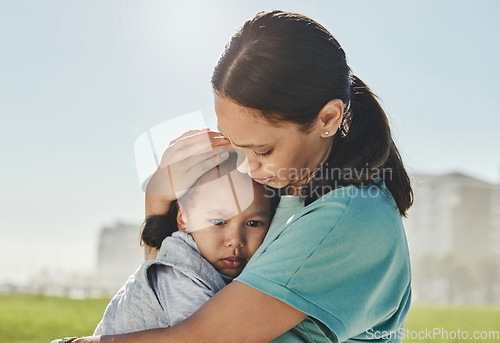 Image of Woman, child and sad with comfort, love and care in hug, embrace and holding outdoor at park. Mom, kid and together for support, attention and help for depression, mental health and problem in sun