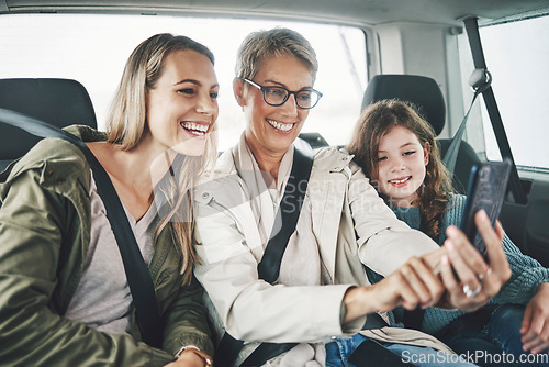 Image of Phone, selfie and happy family in a car for a road trip driving or traveling to a holiday vacation adventure together. Grandma, mother and excited girl or child enjoy pictures for a fun weekend