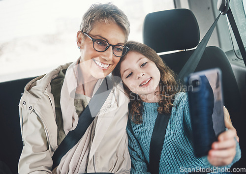 Image of Grandmother, girl and selfie with phone in a car while on a road trip for social media post online. Senior woman and kid smile, photo and happy with travel holiday with 5g smartphone in Germany