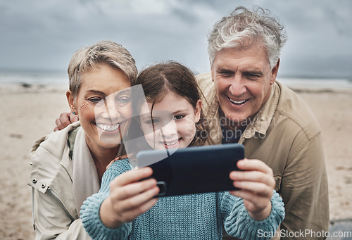 Image of Phone selfie, beach and grandparents with child bond on relax adventure, fun travel journey or Sydney Australia vacation. Memory picture, love and happy family of grandpa, kid girl and grandma smile