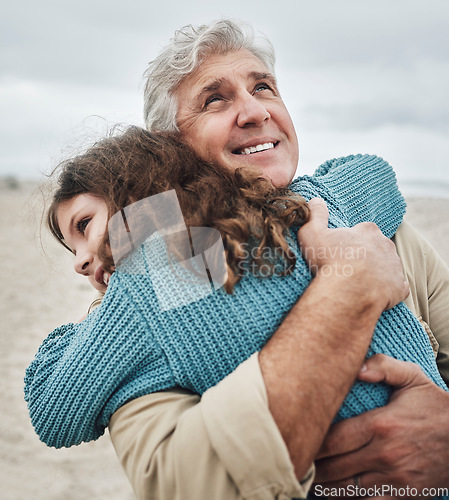 Image of Family, children and hug with a girl and grandfather embracing on the beach outdoor during a holiday or vacation. Travel, kids and love with a senior man thankful for his granddaughter by the sea