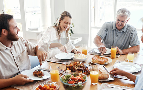 Image of Lunch, family home celebration and grandparents hosting a dinner at kitchen table with smile, food or breakfast. Couple, food and senior people eating meal together with love in their happy house