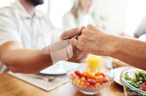 Image of Family, hands and thanksgiving lunch prayer in house, home and restaurant with men, women and food. Zoom, worship praying community with hand, parents or seniors for festive food at dinner table