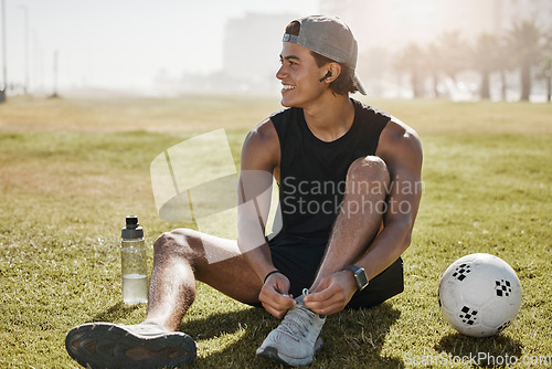 Image of Soccer field, sports gear and man on field, tying shoe laces for competition, game prepare or outdoor training. Gen z college or university person with sneakers for outdoor football practice on pitch