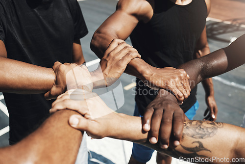 Image of Diversity team, friends and basketball holding hands for trust, partnership or community goal on New york basketball court. Motivation, support or sports unity for fitness, training or health workout