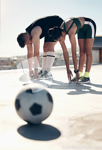 Image of Athletes stretching, soccer player and couple workout on rooftop for sports fitness exercise in summer sun. Urban sports, football player training and stretch together for cardio health cityscape run