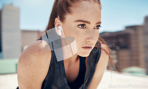 Image of Fitness face, thinking and focus woman city training, sports exercise or outdoor workout with music earphones. Female runner challenge, mental vision and mindset goals, breathe and running motivation