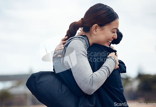 Image of Women, hug or support in fitness success, workout goals or exercise target in the Indonesian city. Smile, happy or celebration embrace sports people, bonding friends or runners after winning marathon