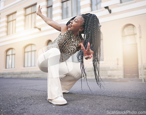 Image of Black woman, street fashion and peace hand sign in city, squat and tongue out in unique self expression. Gen z, trendy and cool, creative and urban girl from Nigeria with stylish designer clothes.