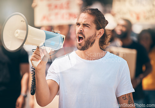 Image of Megaphone, protest and man leader speaking at rally for politics, equality and human rights. Revolution, outdoor strike and guy shouting with microphone for leadership justice speech in road for riot