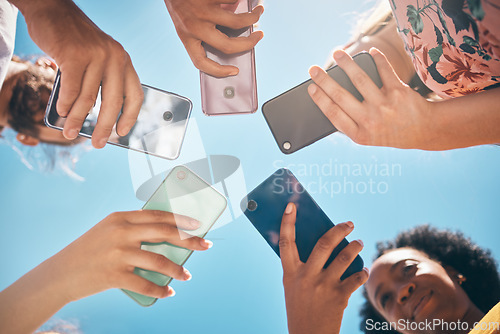 Image of Phone circle, hands of people and low angle, communication or text. Blue sky, mobile and friends on social media, online group chat or wifi, sharing 5g data and surfing internet, web or online.