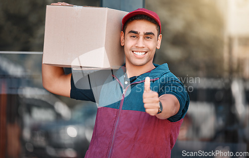 Image of Portrait, box and delivery worker with thumbs up gesture and a big smile carrying cargo, stock or a package. Happy delivery man with a thumb up holding a cardboard packaging or mail post outdoors