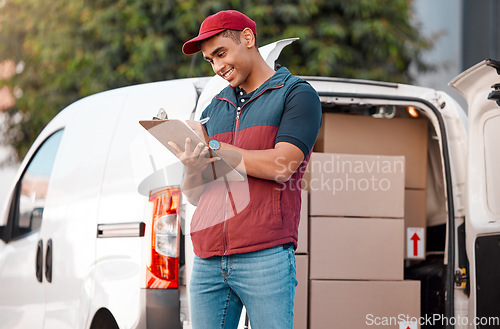 Image of Delivery, inventory and courier writing on paperwork while working in the ecommerce business. Happy, young and logistics worker with smile for documents, paper and transportation of boxes in a van