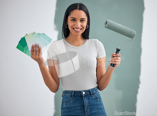 Image of Color card, renovation and woman painting a house, home or apartment room wall green for maintenance. Artistic, designer and creative painter holding a roller and color palette with a happy smile