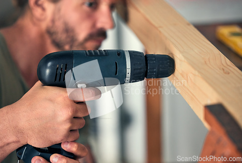 Image of Man, drill wood and build for home interior or wardrobe renovation. Professional carpenter, house construction improvement and focused handyman maintenance worker drilling hole in wooden bar