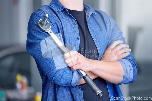 Image of Mechanic with socket wrench, car maintenance and man in workshop for auto repair and mechanical engineering. Automobile technician arms, transportation engineer and tool, working and f1 industry.