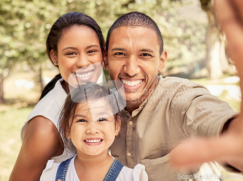 Image of Selfie, family and park with a black couple and foster asian girl child posing for a photograph together outdoor. Children, picture and summer with adopted parents and their daughter bonding outside