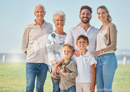 Image of Happy, big family and nature park vacation together with grandparents in retirement, children and parents smile. Summer holiday, relax outdoors and portrait of generations love bonding field of grass