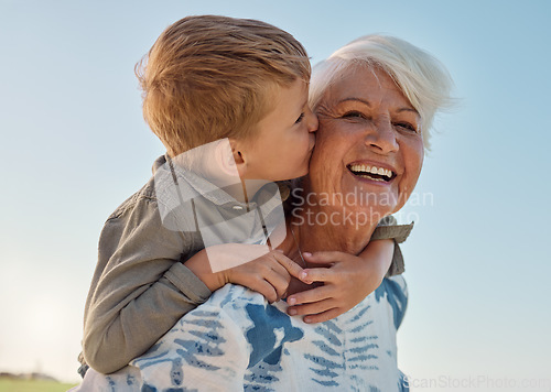 Image of Kiss, child and grandmother in a park with love, care and freedom for happiness in retirement. Senior, smile and portrait of a woman with hug from a kid and kissing in nature or park with piggyback