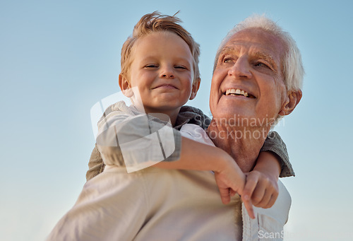 Image of Piggyback, child and grandfather with smile in nature for freedom, love and relax with a blue sky. Portrait of a young, happy and playful kid being funny, bonding and crazy with a senior man in park