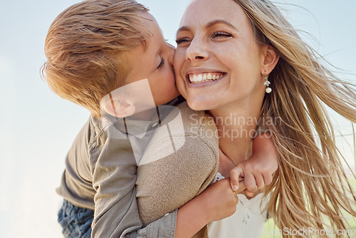 Image of Kiss, mother and child with smile in a park for relax, adventure and peace together in summer. Face of a happy, thinking and young mom with her kid kissing and hugging her in nature with a piggyback