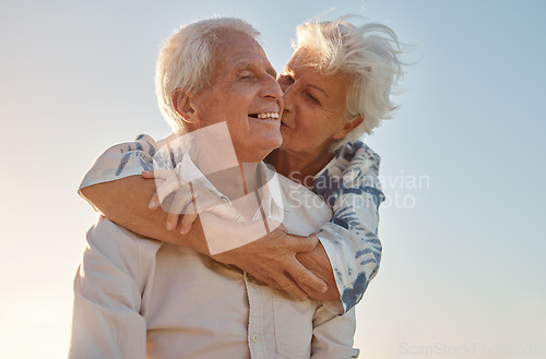 Image of Kiss, hug and senior couple with love, care and happiness in their marriage together in nature. Happy, relax and smile from an elderly man and woman hugging and kissing for gratitude and commitment