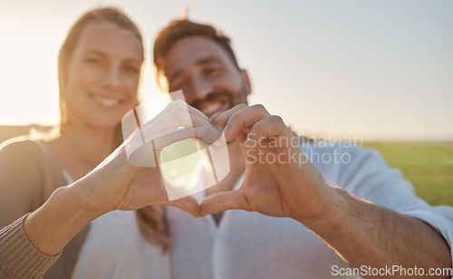Image of Heart, hands and couple with smile in a park for love, care and adventure in their marriage together in France. Happy, young and man and woman on date in nature with a loving gesture with hands