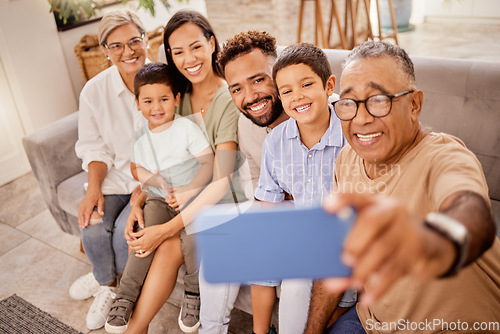 Image of Selfie, family and phone with grandfather taking a photograph of his grandchildren and their parents at home. Kids, photo and big family smile, happy and social media in living room with smartphone