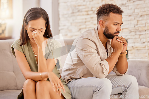 Image of Couple, divorce or stress on living room sofa in house, home or marriage counseling after fight, argument or affair. Sad, anxiety or depression for man or woman with mental health or breakup burnout