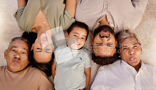 Image of Relax, portrait and happy family with funny faces or crazy facial expressions lying on a floor, top view. Grandparent, mother and father love freedom, bonding and enjoy quality time at home together