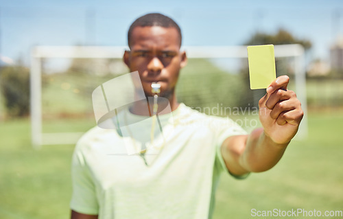 Image of Soccer, referee and yellow card with a black man giving a caution to a player during a game outdoor. Football, fitness and exercise with a young male booking an athlete during a match outside