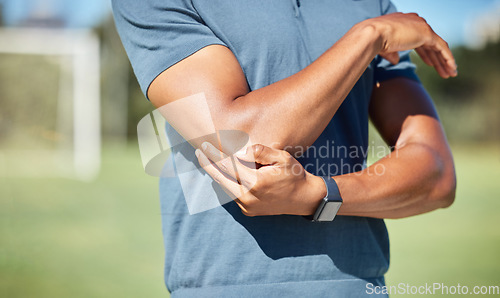 Image of Sports man with elbow pain on arm, injury in outdoor soccer field. Hand massage bone, person with emergency muscle problem, physiotherapy in sport and joint accident with physical therapy