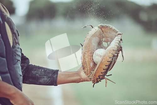 Image of Baseball, sports and catch with a man athlete catching a ball at a game on a field or grass pitch. Fitness, health and sport with a male baseball player playing a match at a sport venue for exercise