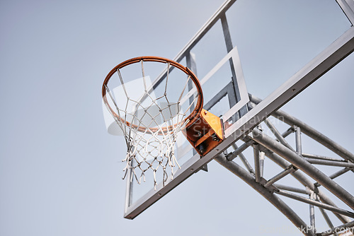 Image of Basketball court, fabric or goals net for match, competition game or fitness in low angle on blue sky in New York. Basketball hoop, texture or sports exercise for training, wellness or winner workout