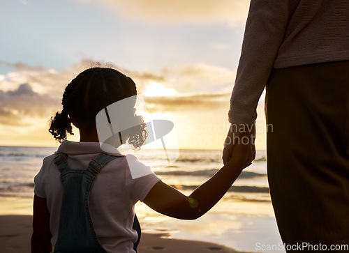 Image of Hand holding, girl and parent at a sunset, beach waves and ocean with family love and calm mindset. Nature, sea and water view with a child feeling care and relax outdoor with a peaceful experience