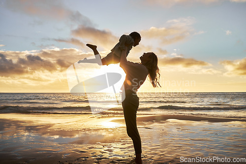 Image of Mother, girl and sunset silhouette at beach while play, lift and love during summer vacation in Hawaii. Woman, child and energy with fun, carry and care during family travel holiday at Hawaii sea