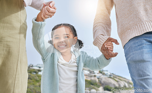 Image of Family, holding hands and girl smile in nature on vacation, holiday or summer trip. Love, support and man, woman and happy kid bonding, care or spending quality time together outdoors on walk outside