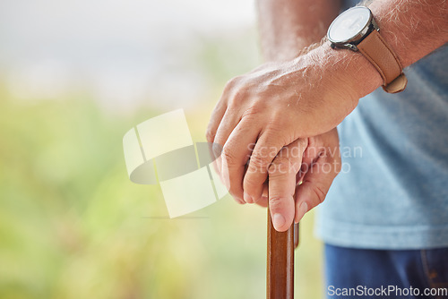 Image of Disability, senior man and hands on stick for support while walking in a retirement home. Disabled, Handicap and elderly male patient holding a walk aid or cane in a healthcare nursing facility.