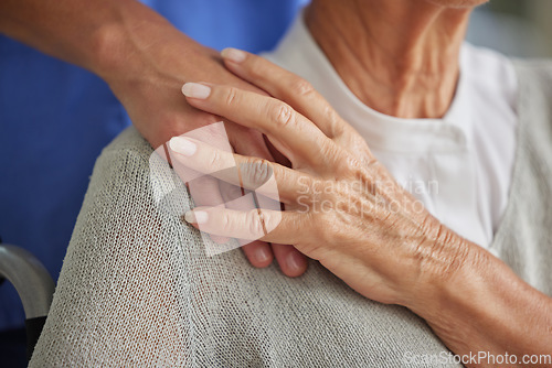 Image of Comfort, hand and nurse with senior for care in wheelchair at house, nursing home or retirement. Zoom, hands and touch on shoulder for compassion, elderly and support for healthcare in disability